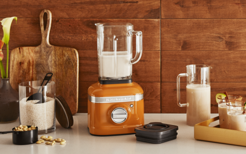 KitchenAid® blender with orange base half-filled with almond milk