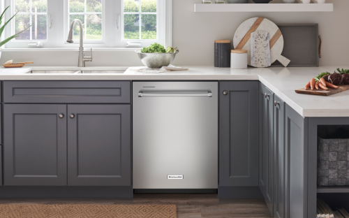 Silver KitchenAid® dishwasher in dark gray cabinetry.