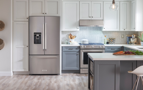 A stainless steel KitchenAid® French door refrigerator in a modern kitchen.