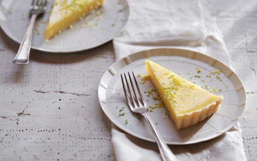  A piece of lemon pie on a plate.