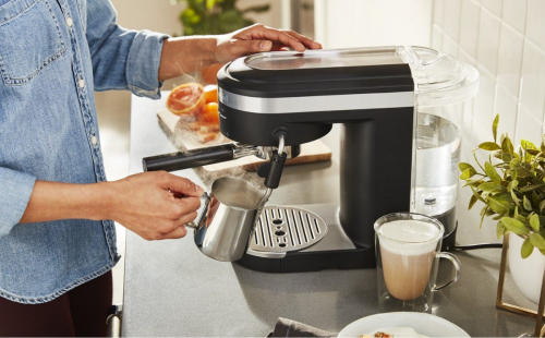 Person making a drink at an espresso machine