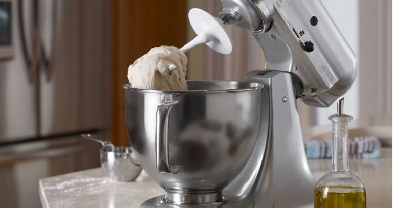 A KitchenAid stand mixer with dough hook and mixture