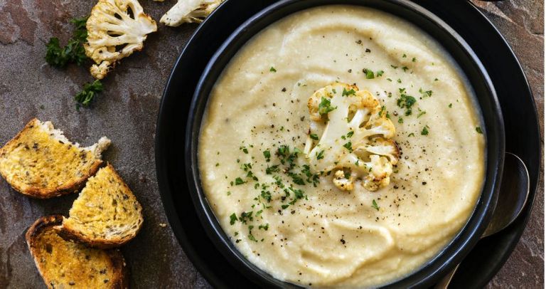 A bowl of creamy cauliflower soup