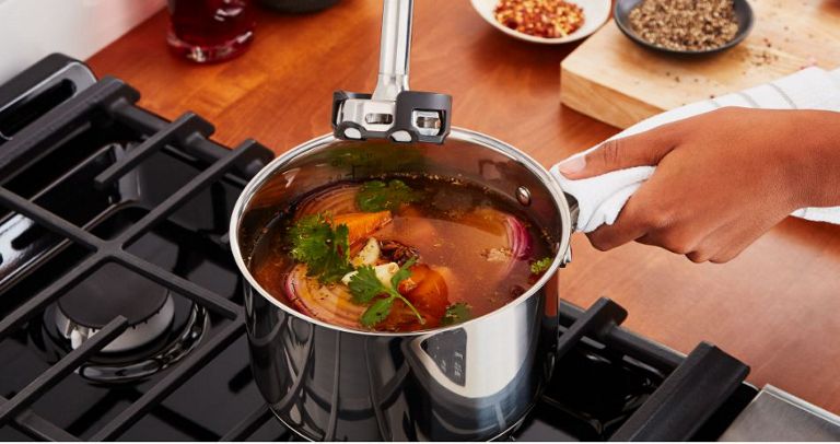 A pot with broth and vegetables being prepared for blending