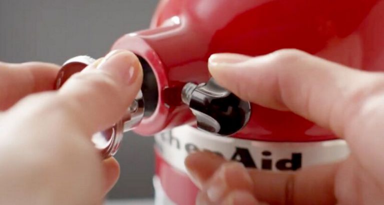 Woman connects an attachment into the power hub on a KitchenAid Stand Mixer