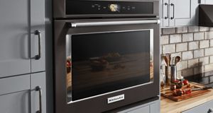 In a charming kitchen setting, a stunning black KitchenAid wall oven is featured.